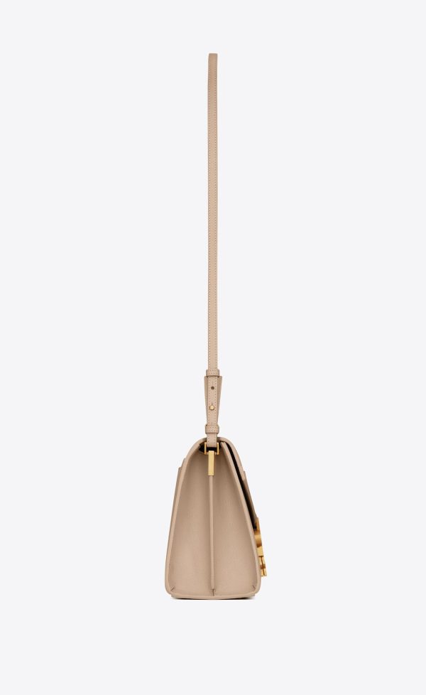 cassandra medium top handle bag in grain de poudre embossed leather dark beige