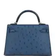 this kelly, in the sellier style, is in vert rousseau madame leather and shiny niloticus crocodile with gold hardware and has tonal stitching,front flap, two straps with center toggle closure, clochette with lock and two keys, single rolled top handle and removable shoulder strap. the interior is lined in vert rousseau chevre and has one zip pocket with hermes engraved pull and one open pocket on the opposite side. collection: u origin: france condition: pristine; new or never worn (plastic on hardware) accompanied by: hermes box, hermes dustbag, clochette, lock, two keys, shoulder strap, clochette dustbag, shoulder strap dustbag, felt, rainhat, ribbon, cites and carebook measurements: 9.8" width x 7.5" height x 3.5" depth; 3.5" handle drop this kelly, in the sellier style, is in vert rousseau madame leather and shiny niloticus crocodile with gold hardware and has tonal stitching,front flap, two straps with center toggle closure, clochette with lock and two keys, single rolled top handle and removable shoulder strap. the interior is lined in vert rousseau chevre and has one zip pocket with hermes engraved pull and one open pocket on the opposite side. collection: u origin: france condition: pristine; new or never worn (plastic on hardware) accompanied by: hermes box, hermes dustbag, clochette, lock, two keys, shoulder strap, clochette dustbag, shoulder strap dustbag, felt, rainhat, ribbon, cites and carebook measurements: 9.8" width x 7.5" height x 3.5" depth; 3.5" handle drop