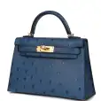 this kelly, in the sellier style, is in vert rousseau madame leather and shiny niloticus crocodile with gold hardware and has tonal stitching,front flap, two straps with center toggle closure, clochette with lock and two keys, single rolled top handle and removable shoulder strap. the interior is lined in vert rousseau chevre and has one zip pocket with hermes engraved pull and one open pocket on the opposite side. collection: u origin: france condition: pristine; new or never worn (plastic on hardware) accompanied by: hermes box, hermes dustbag, clochette, lock, two keys, shoulder strap, clochette dustbag, shoulder strap dustbag, felt, rainhat, ribbon, cites and carebook measurements: 9.8" width x 7.5" height x 3.5" depth; 3.5" handle drop this kelly, in the sellier style, is in vert rousseau madame leather and shiny niloticus crocodile with gold hardware and has tonal stitching,front flap, two straps with center toggle closure, clochette with lock and two keys, single rolled top handle and removable shoulder strap. the interior is lined in vert rousseau chevre and has one zip pocket with hermes engraved pull and one open pocket on the opposite side. collection: u origin: france condition: pristine; new or never worn (plastic on hardware) accompanied by: hermes box, hermes dustbag, clochette, lock, two keys, shoulder strap, clochette dustbag, shoulder strap dustbag, felt, rainhat, ribbon, cites and carebook measurements: 9.8" width x 7.5" height x 3.5" depth; 3.5" handle drop